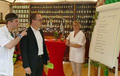 Text-Apotheker Simon Ahlborn (li.) bietet Heilung an bei Liebeskummer, Weltschmerz, und vielem mehr. Kultusminister Grant Hendrik Tonne ließ sich auch voller Interesse in der Text-Apotheke auf der Kirchenmeile beraten. Foto: ELKiO/H.-W. Kögel