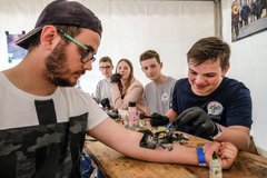 Die Airbrush-Tattoos, die die Evangelische Jugend  auf der Kirchenmeile Jugendlichen "verpasst", sind heiß begehrt. Die Ein-Wochen-Tattoos knüpfen an die Tätowierungs-Tradition bei Seeleuten an. Foto: Jens Schulze